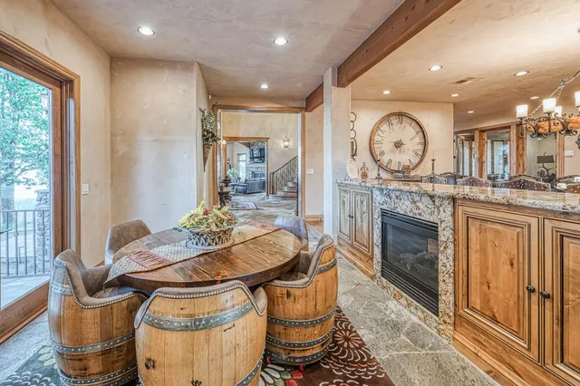 a spacious bedroom with a large bed a flat screen tv and a potted plant