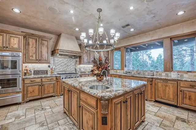 a large bed sitting in a bedroom next to a window