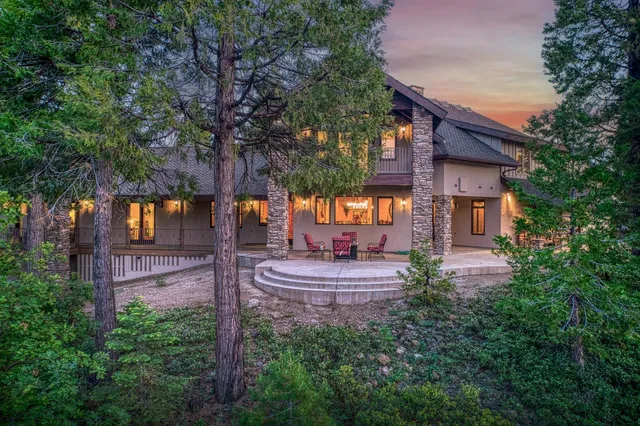 a house view with a sitting space fire pit and outdoor space