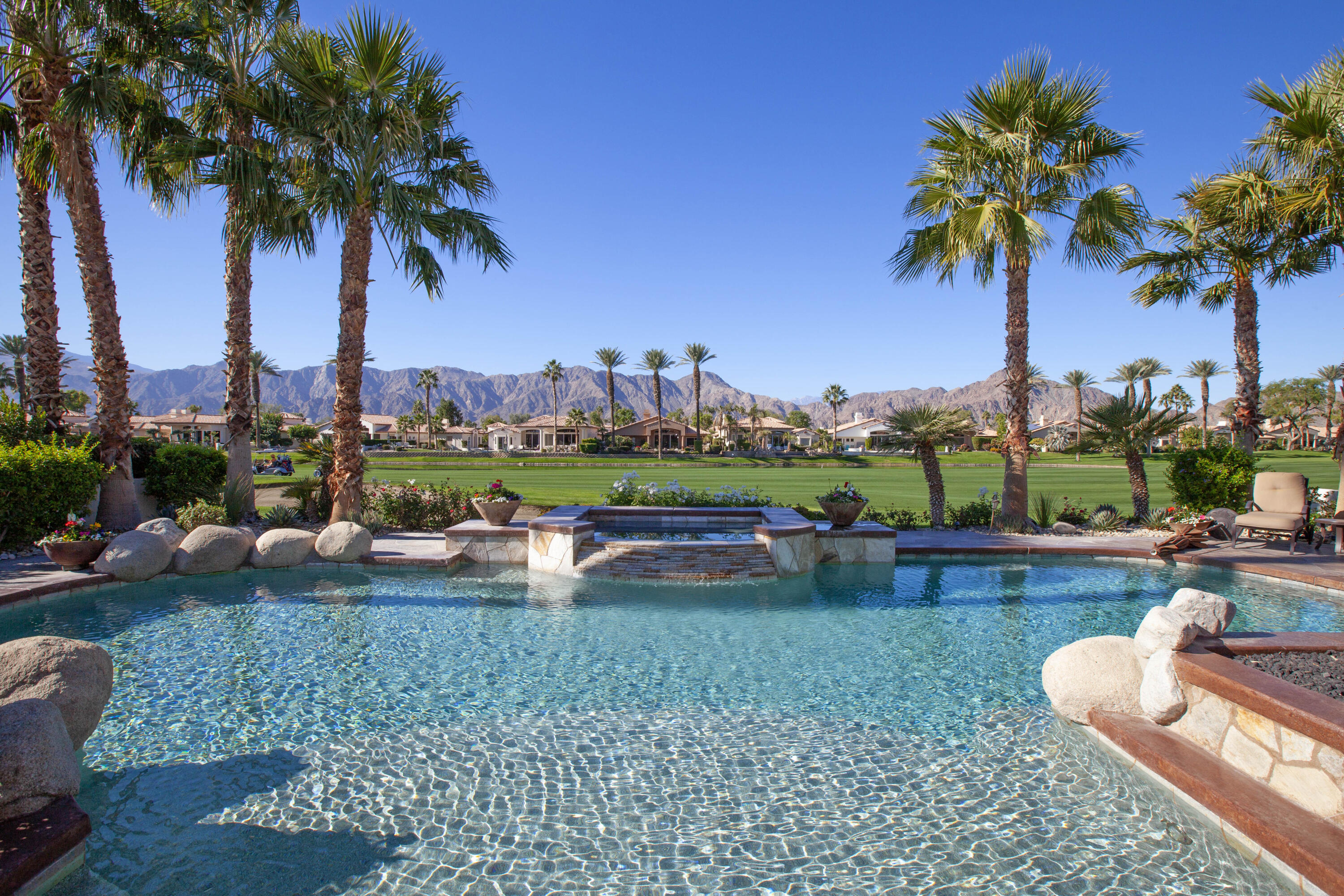 49487 Vía Conquistador La Quinta, CA 92253 - Photo 2 of 49 a view of a backyard with swimming pool and outdoor seating