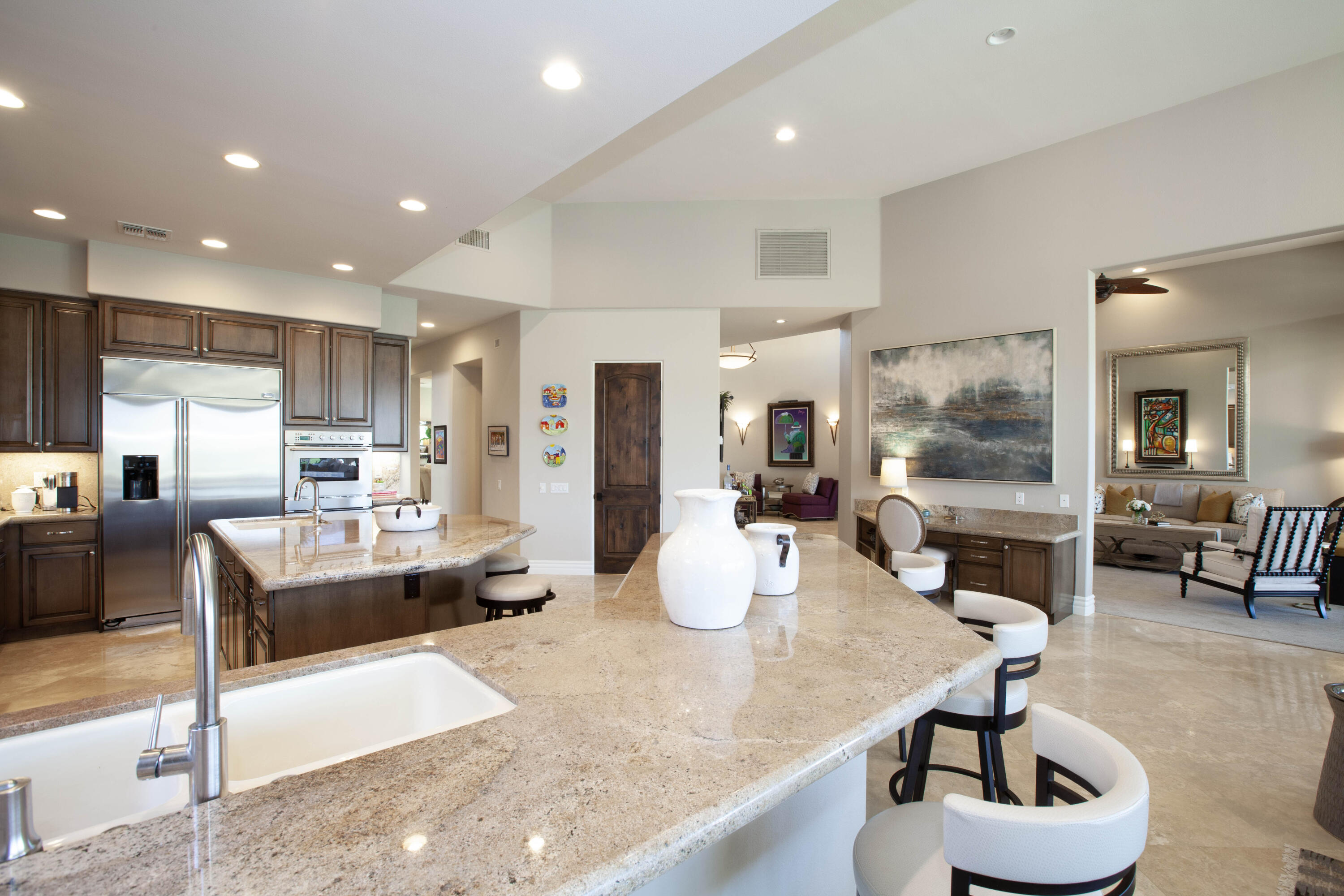 49487 Vía Conquistador La Quinta, CA 92253 - Photo 29 of 49 a living room with kitchen couches and kitchen view with wooden floor
