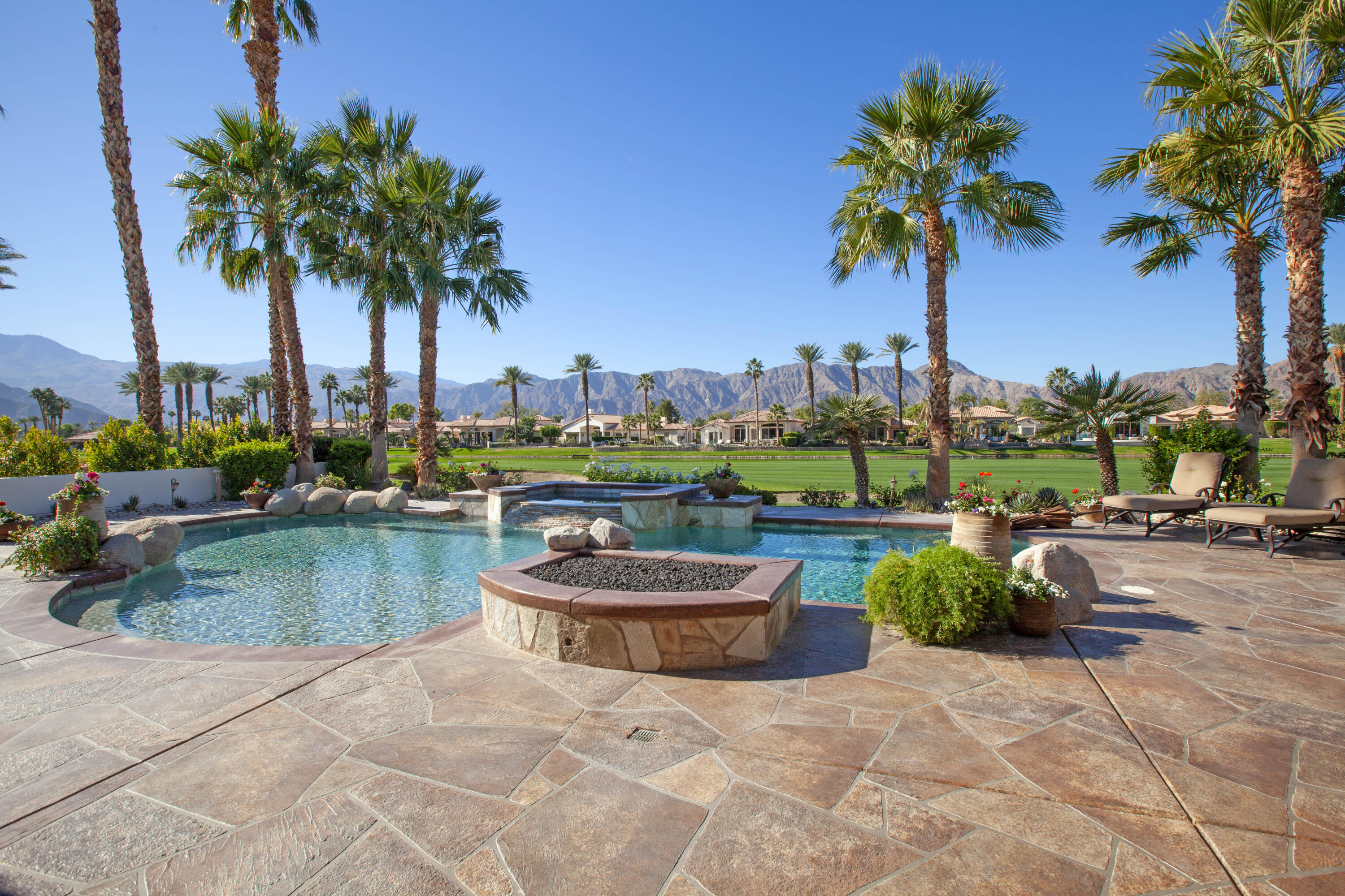 49487 Vía Conquistador La Quinta, CA 92253 - Photo 3 of 49 a view of a swimming pool and a garden