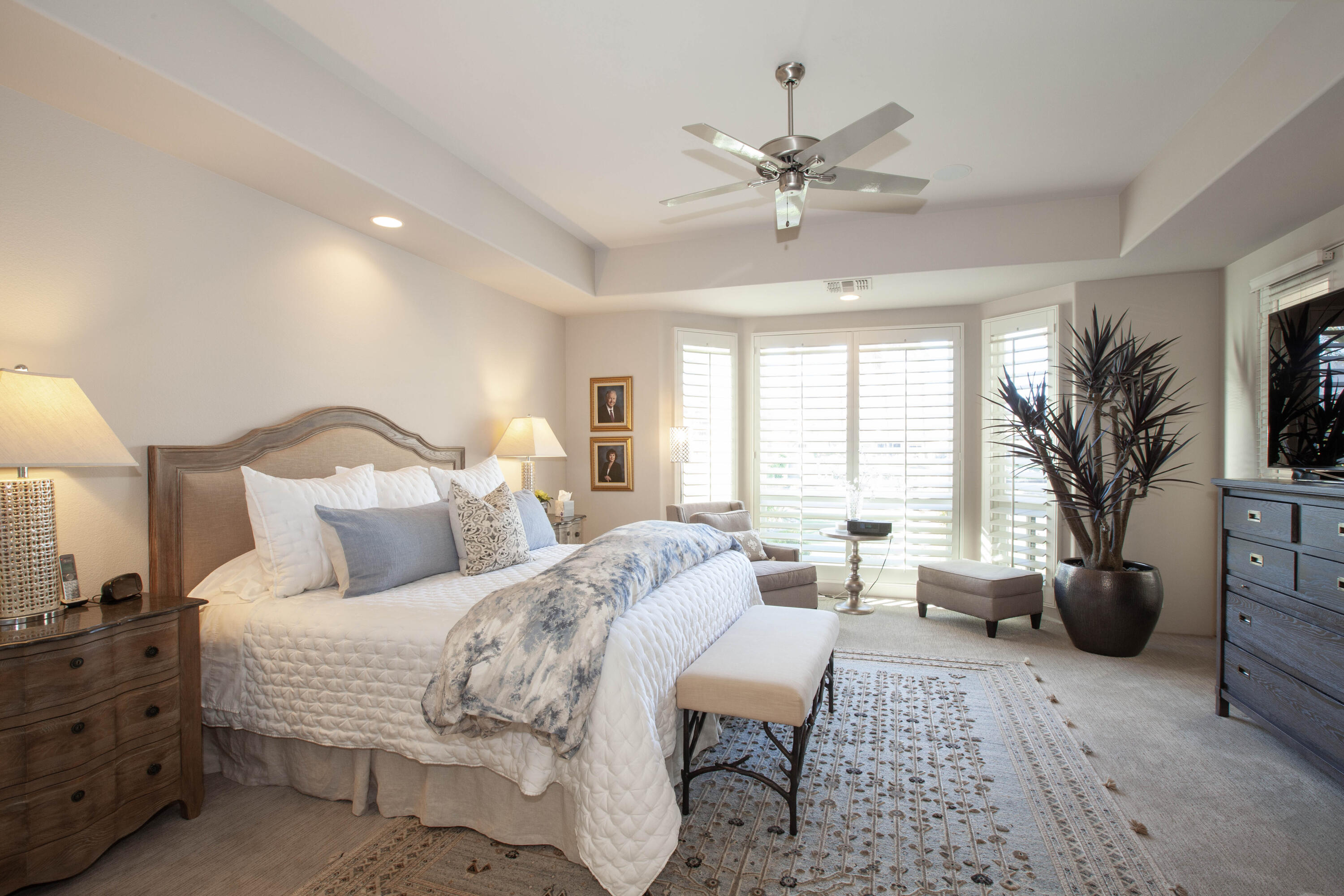49487 Vía Conquistador La Quinta, CA 92253 - Photo 33 of 49 a bedroom with a large bed and a chandelier