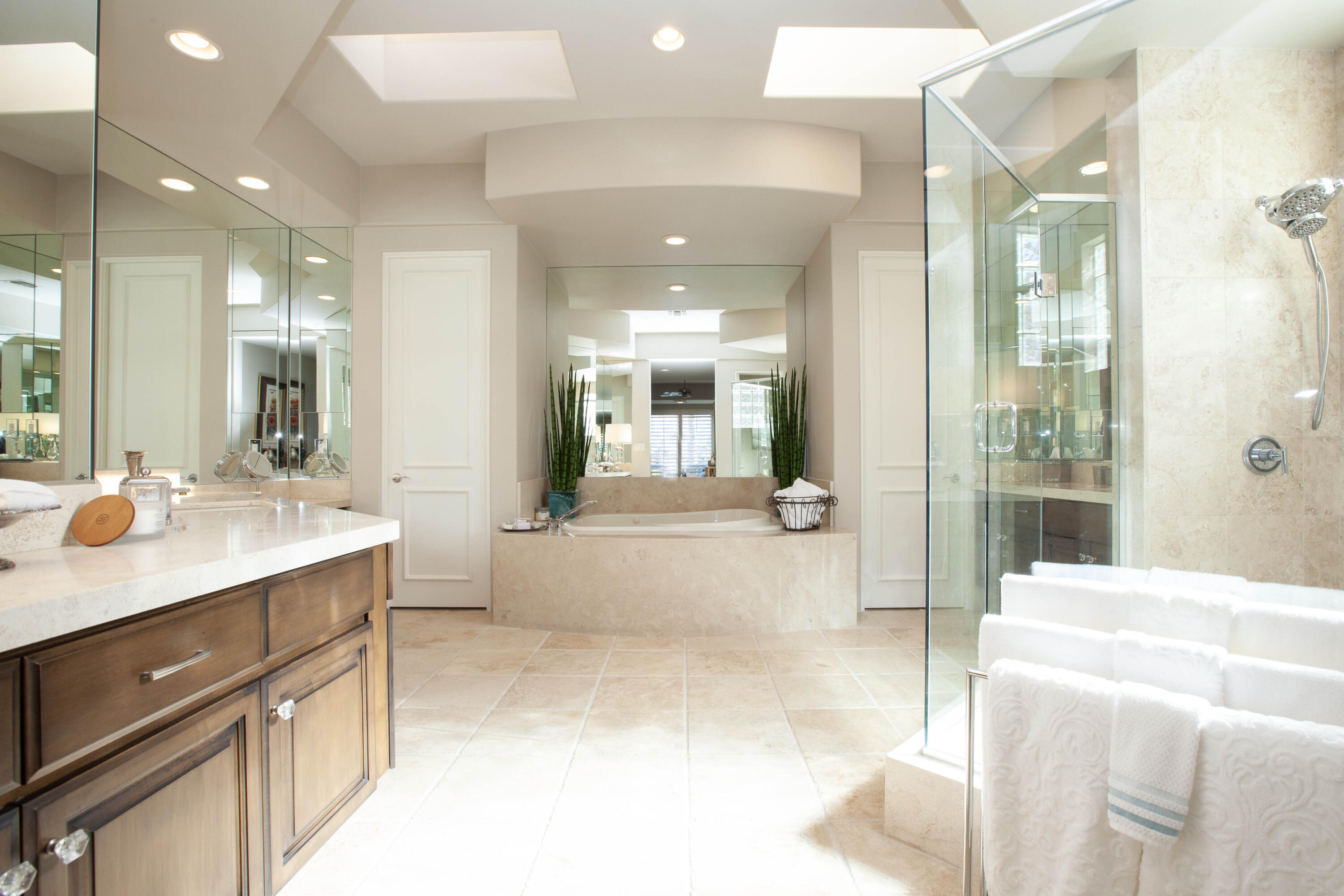49487 Vía Conquistador La Quinta, CA 92253 - Photo 36 of 49 a bathroom with a sink a large mirror and a shower