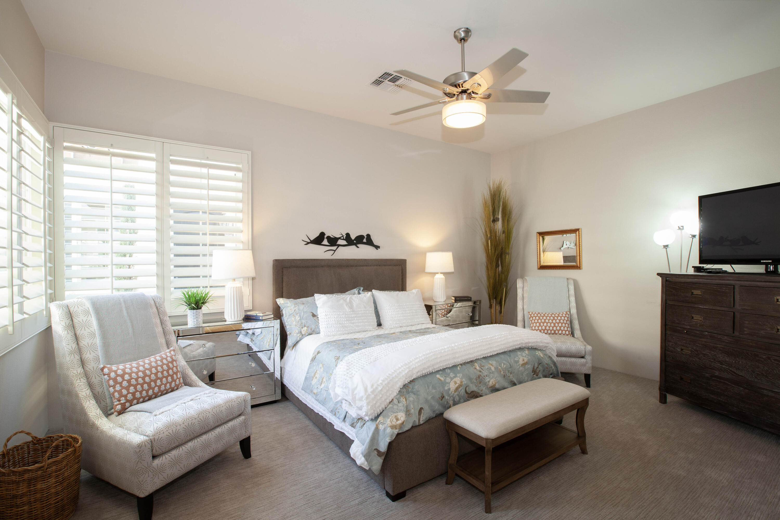 49487 Vía Conquistador La Quinta, CA 92253 - Photo 40 of 49 a bedroom with a bed a couch and a chandelier