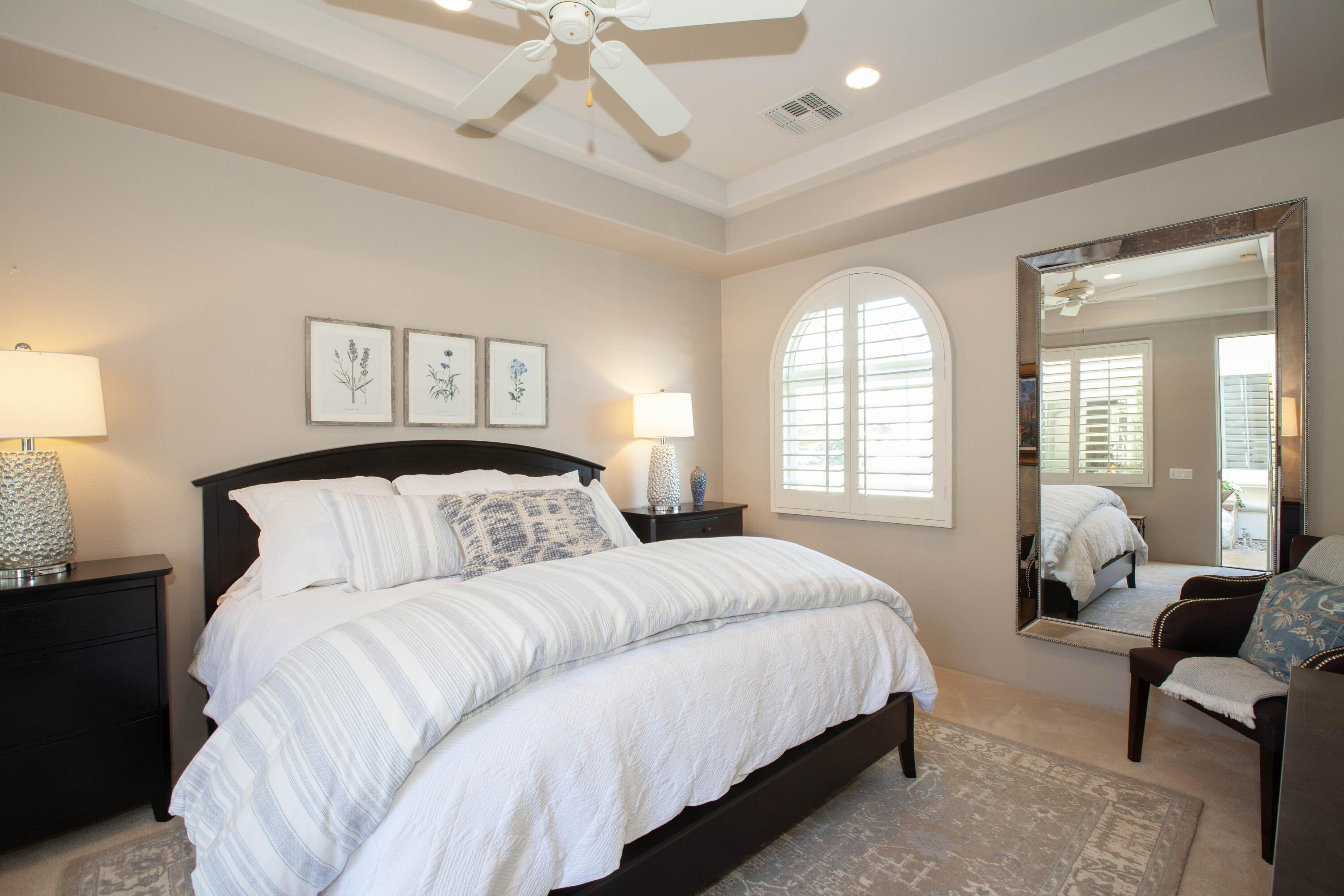 49487 Vía Conquistador La Quinta, CA 92253 - Photo 45 of 49 a spacious bedroom with a bed and a large mirror