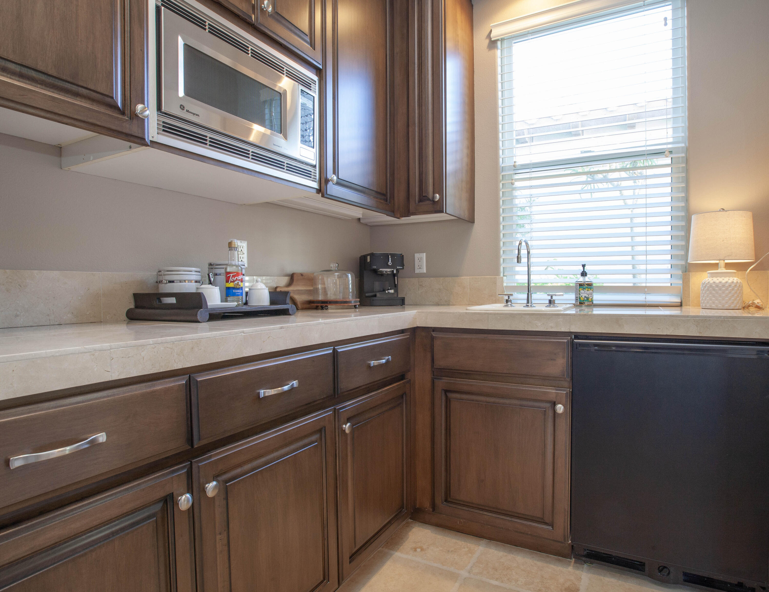 49487 Vía Conquistador La Quinta, CA 92253 - Photo 48 of 49 a kitchen with stainless steel appliances granite countertop a sink and a stove next to a window