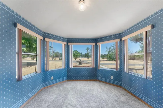 a front view of a house with swimming pool and sitting area