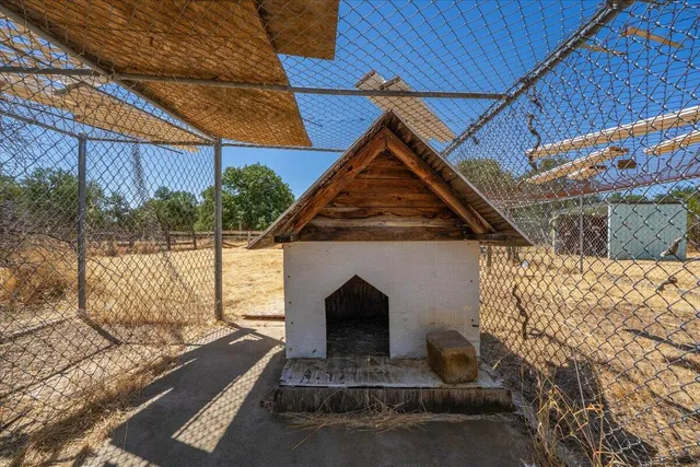 a view of an empty room with wooden floor and windows