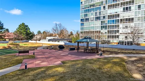 a view of a swimming pool with lawn chairs and a yard