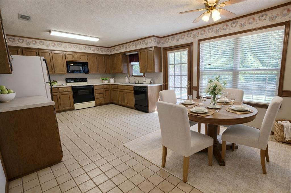 2302 Shiloh Street Denison, TX 75020 - Photo 8 of 16 a view of a dining room with furniture window and outside view