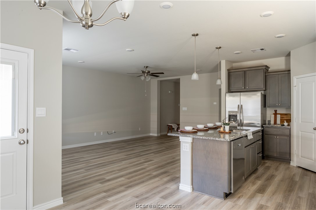 2159 Chief Street Bryan, TX 77807 - Photo 5 of 22 a kitchen with stainless steel appliances a stove a sink and a refrigerator