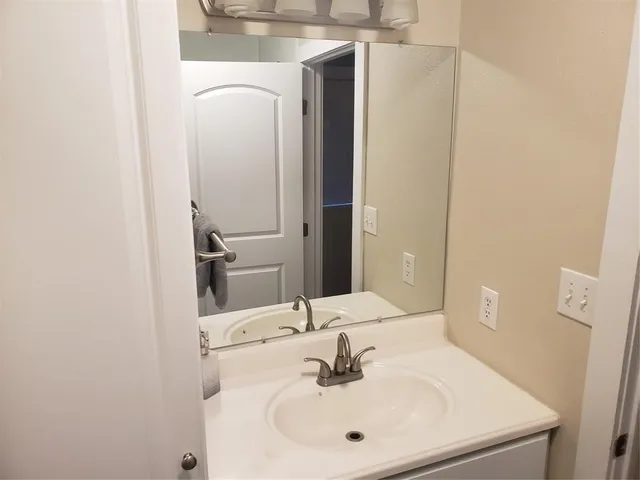 a bathroom with a glass shower door