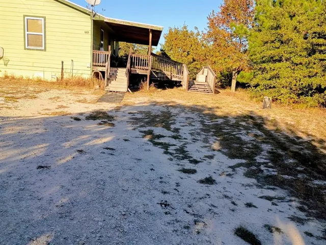 a view of a yard with wooden fence