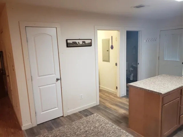 a dining room with furniture and wooden floor