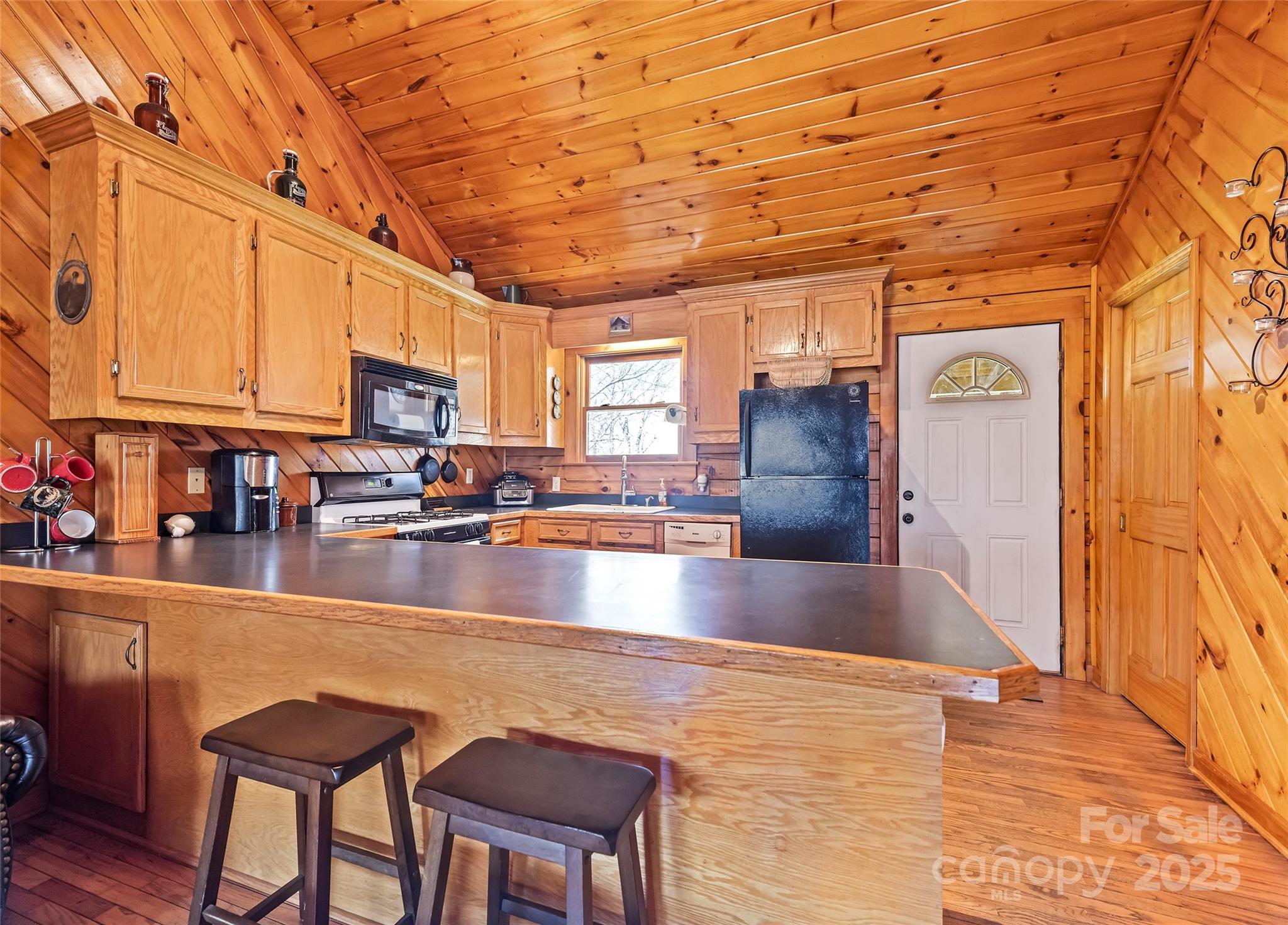 173 Blizzard Ridge Maggie Valley, NC 28751 - Photo 11 of 37 a view of a kitchen with kitchen island a counter top space a sink cabinets and appliances
