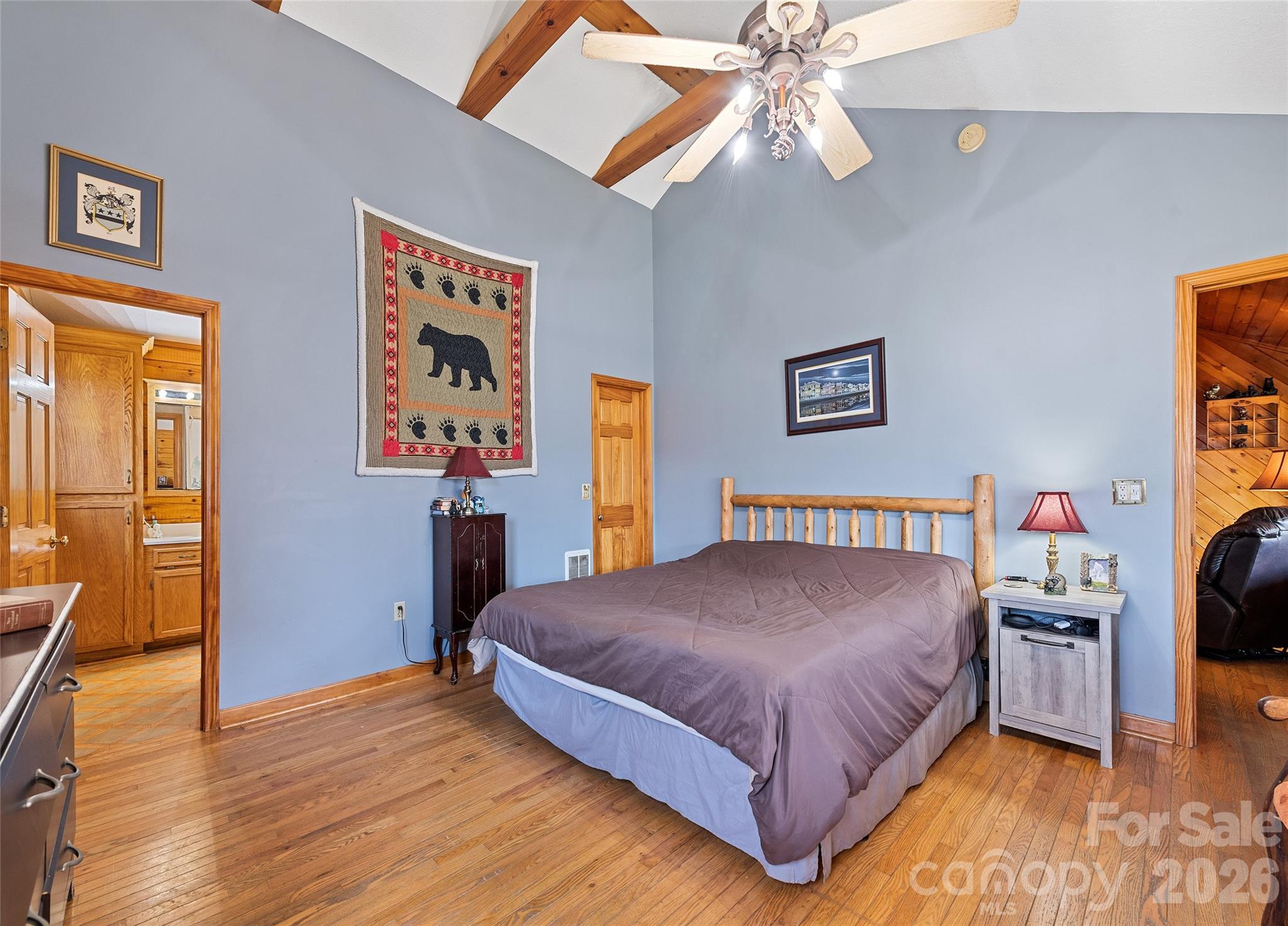 173 Blizzard Ridge Maggie Valley, NC 28751 - Photo 15 of 37 a bedroom with a bed and a chandelier