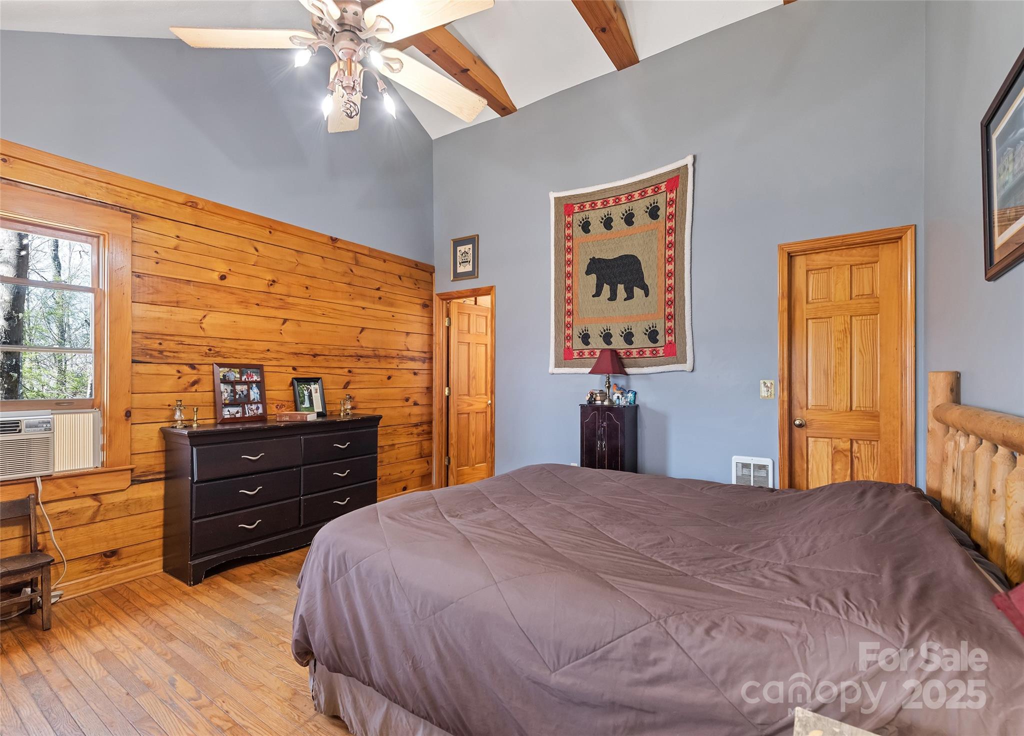 173 Blizzard Ridge Maggie Valley, NC 28751 - Photo 16 of 37 a bedroom with a bed and wooden floor