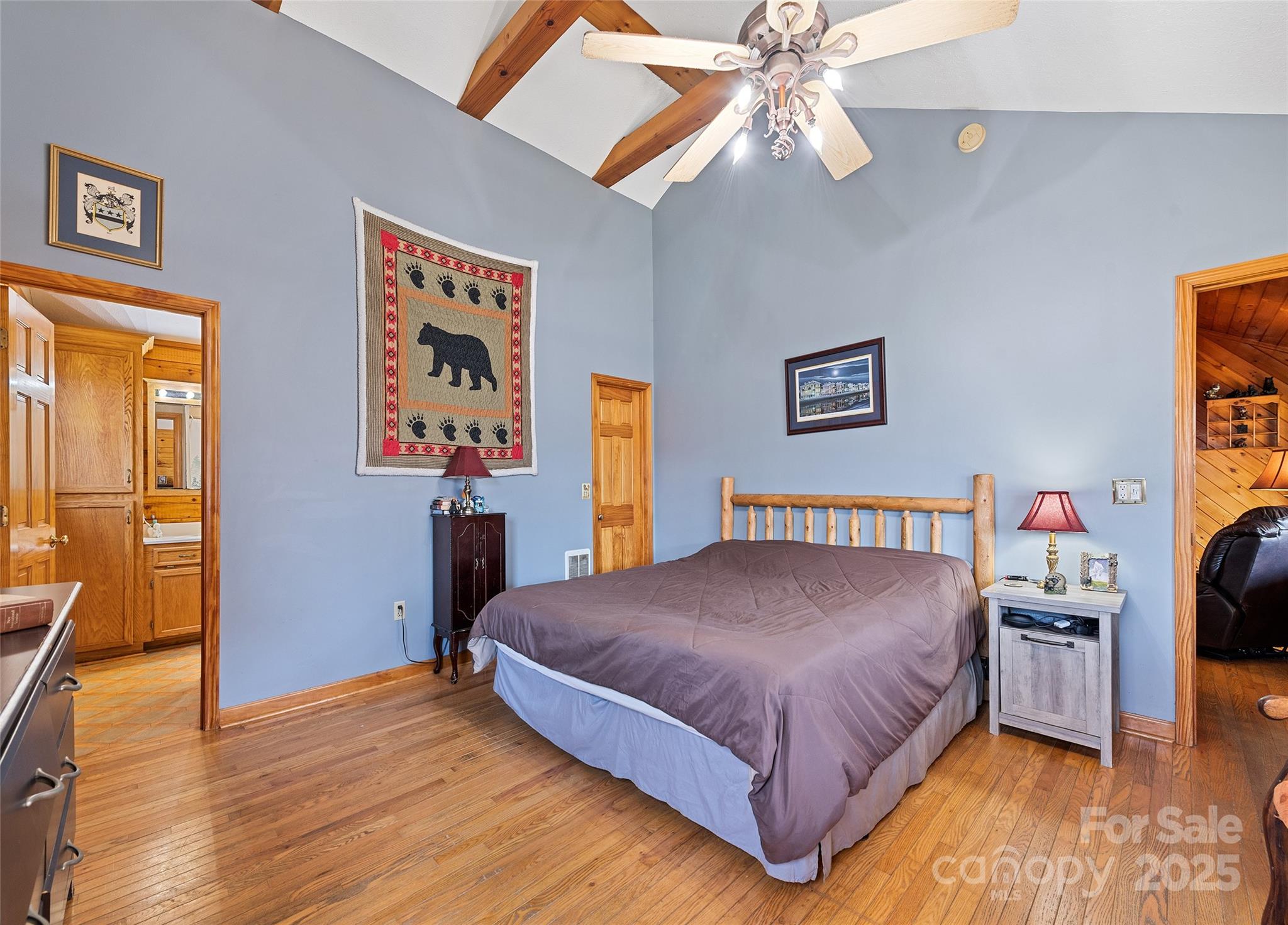 173 Blizzard Ridge Maggie Valley, NC 28751 - Photo 17 of 37 a bedroom with a bed and a chandelier
