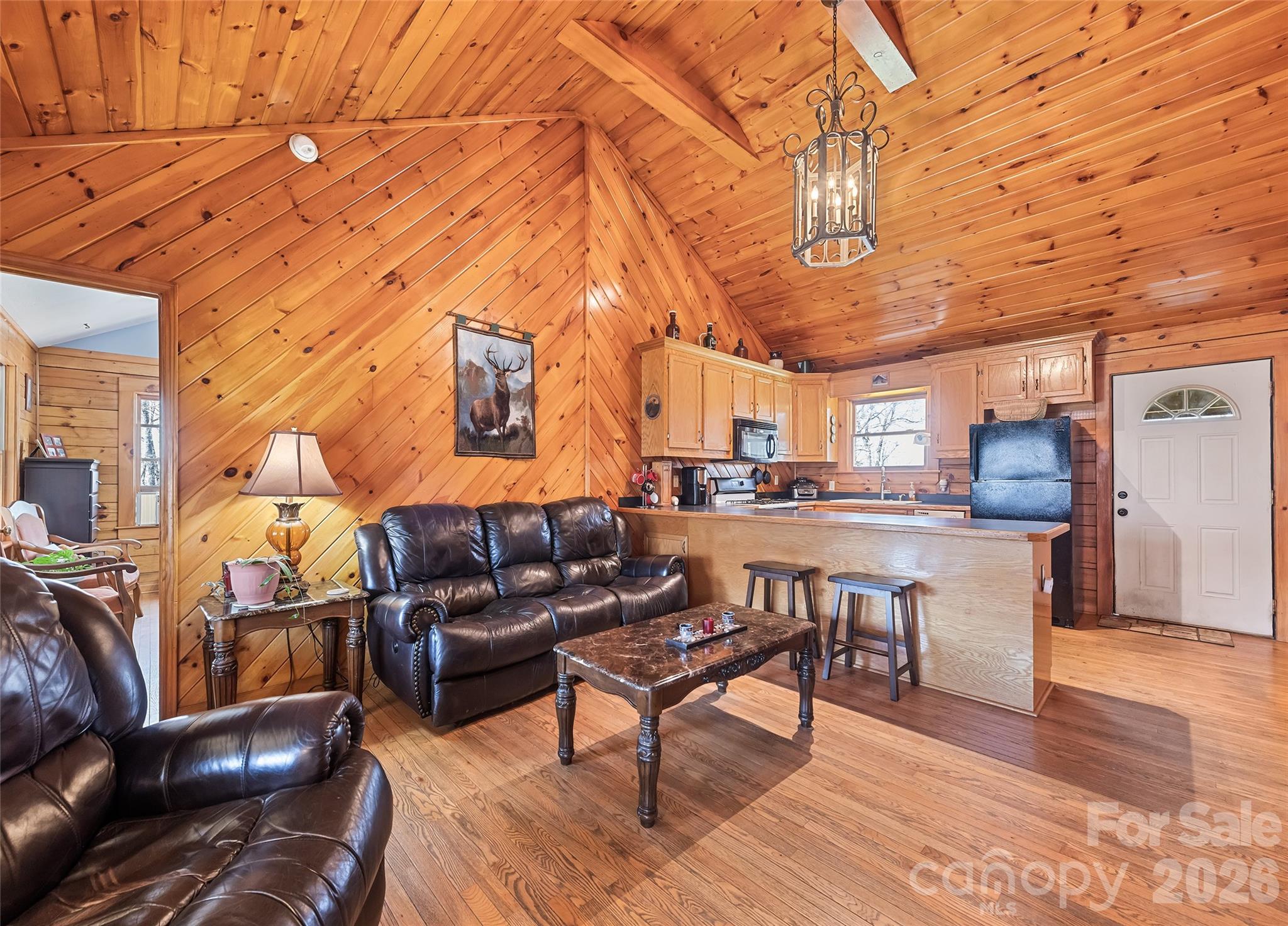 173 Blizzard Ridge Maggie Valley, NC 28751 - Photo 7 of 37 a living room with couch and a dining table with wooden floor