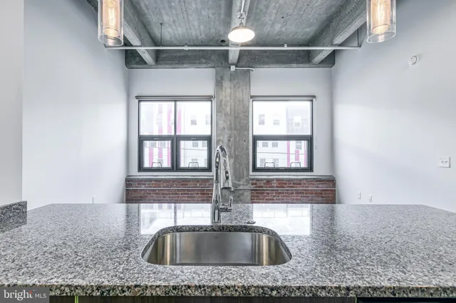 a view of a kitchen from a hallway