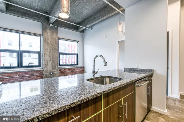 a kitchen with granite countertop a sink and a window