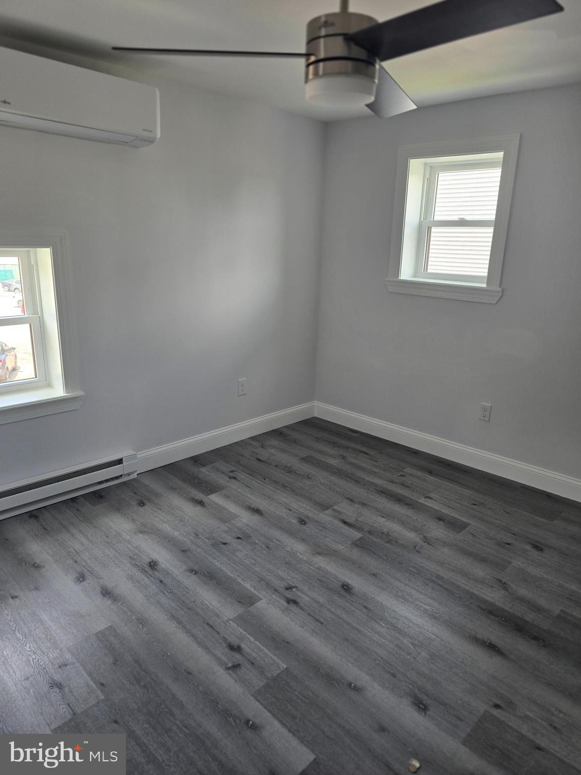 5925 Ridge Avenue, Unit 5 Philadelphia, PA 19128 - Photo 24 of 31 an empty room with wooden floor and windows
