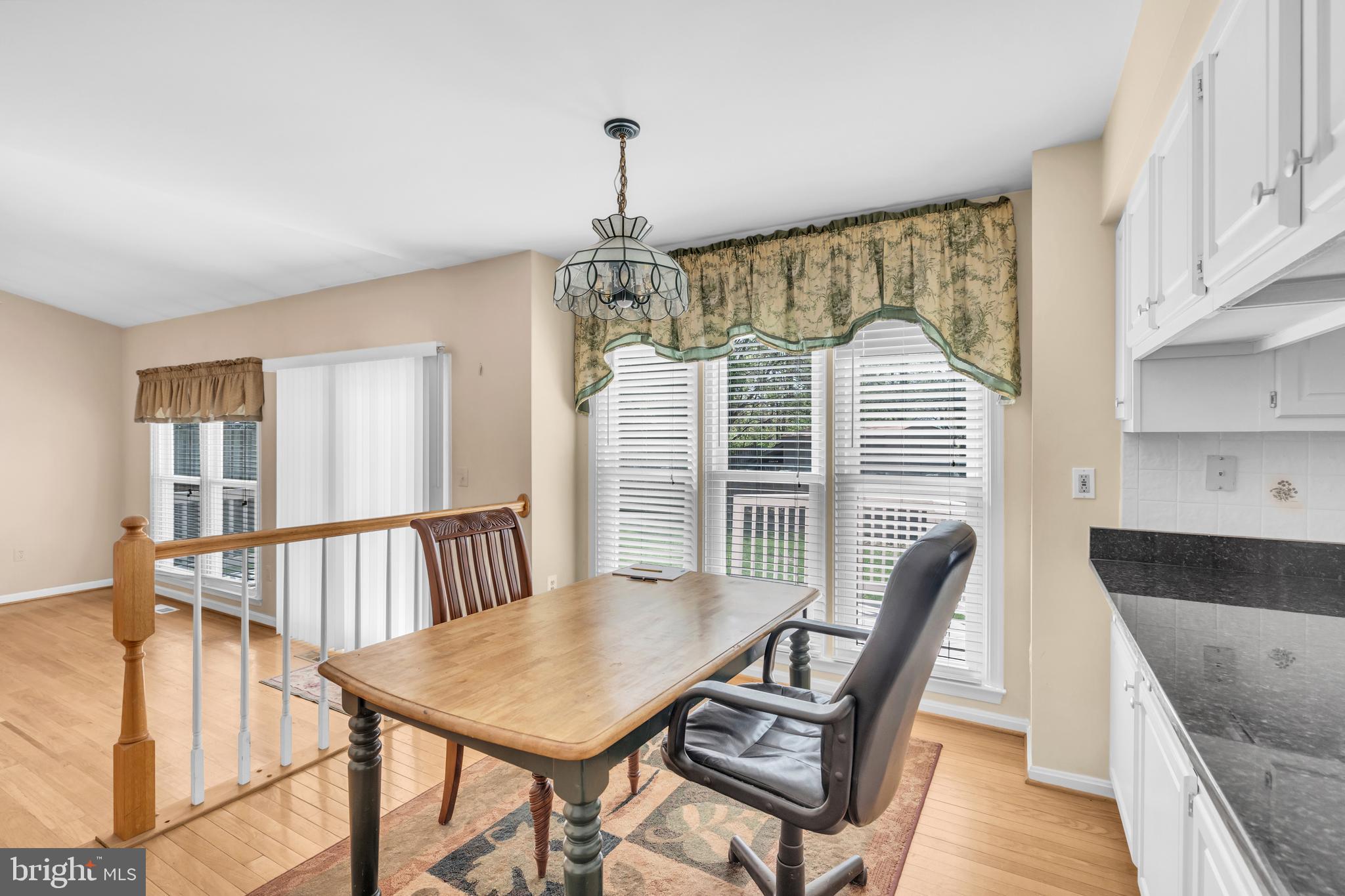 13988 Dancing Twig Drive Gainesville, VA 20155 - Photo 20 of 62 a view of a dining room with furniture window and wooden floor