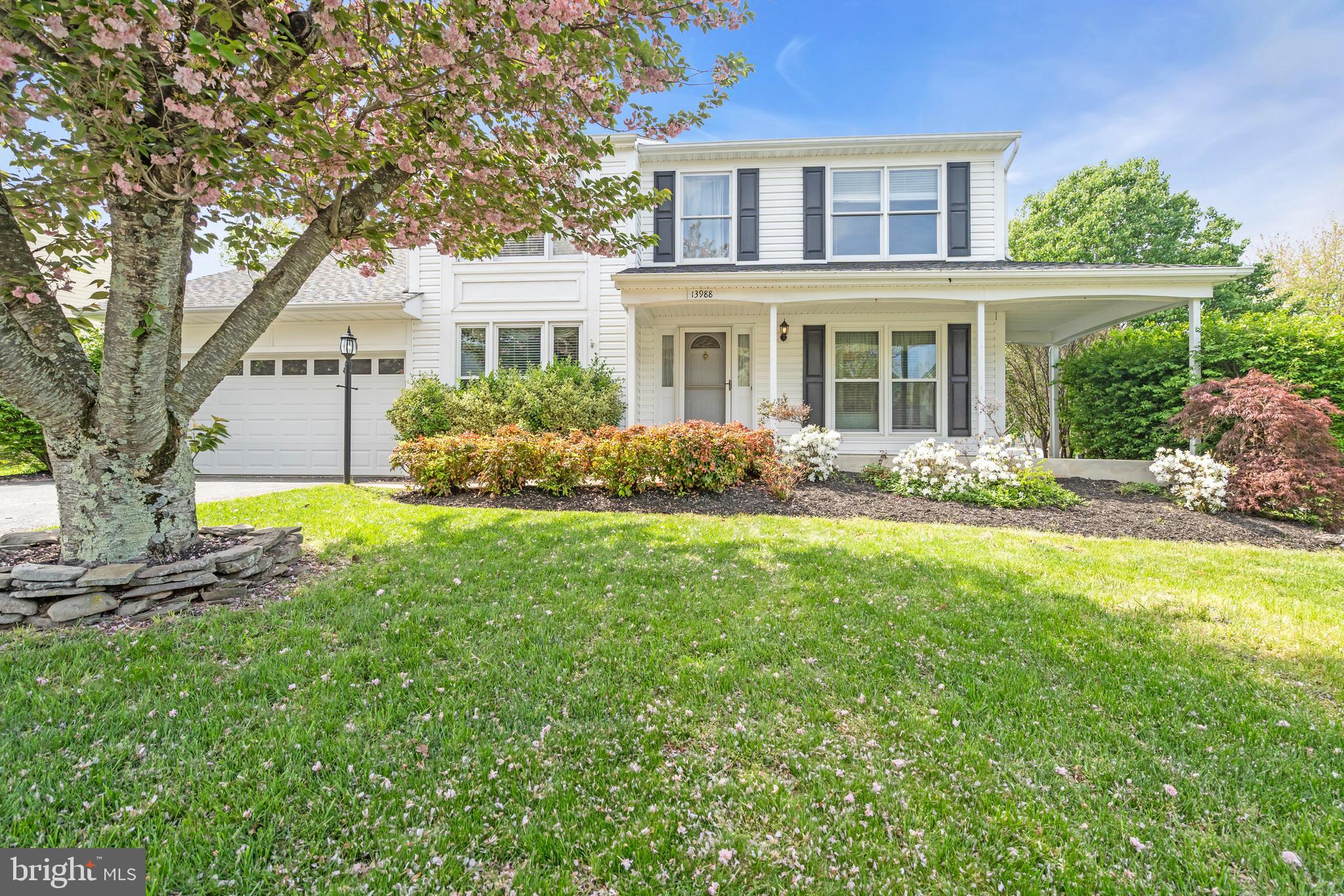 13988 Dancing Twig Drive Gainesville, VA 20155 - Photo 2 of 62 a front view of a house with garden