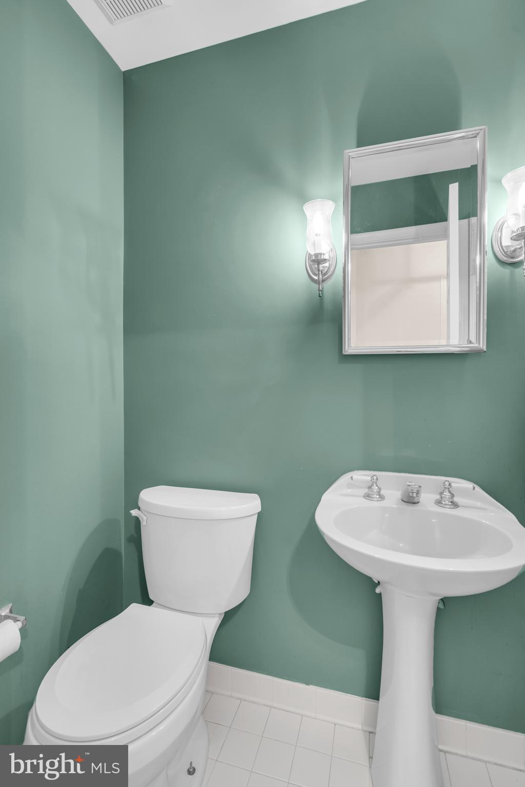 13988 Dancing Twig Drive Gainesville, VA 20155 - Photo 25 of 62 a white toilet sitting next to a bathroom sink