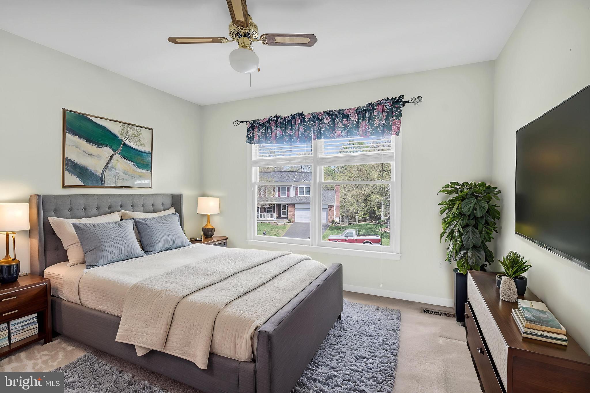 13988 Dancing Twig Drive Gainesville, VA 20155 - Photo 37 of 62 a bedroom with a large bed and a flat screen tv