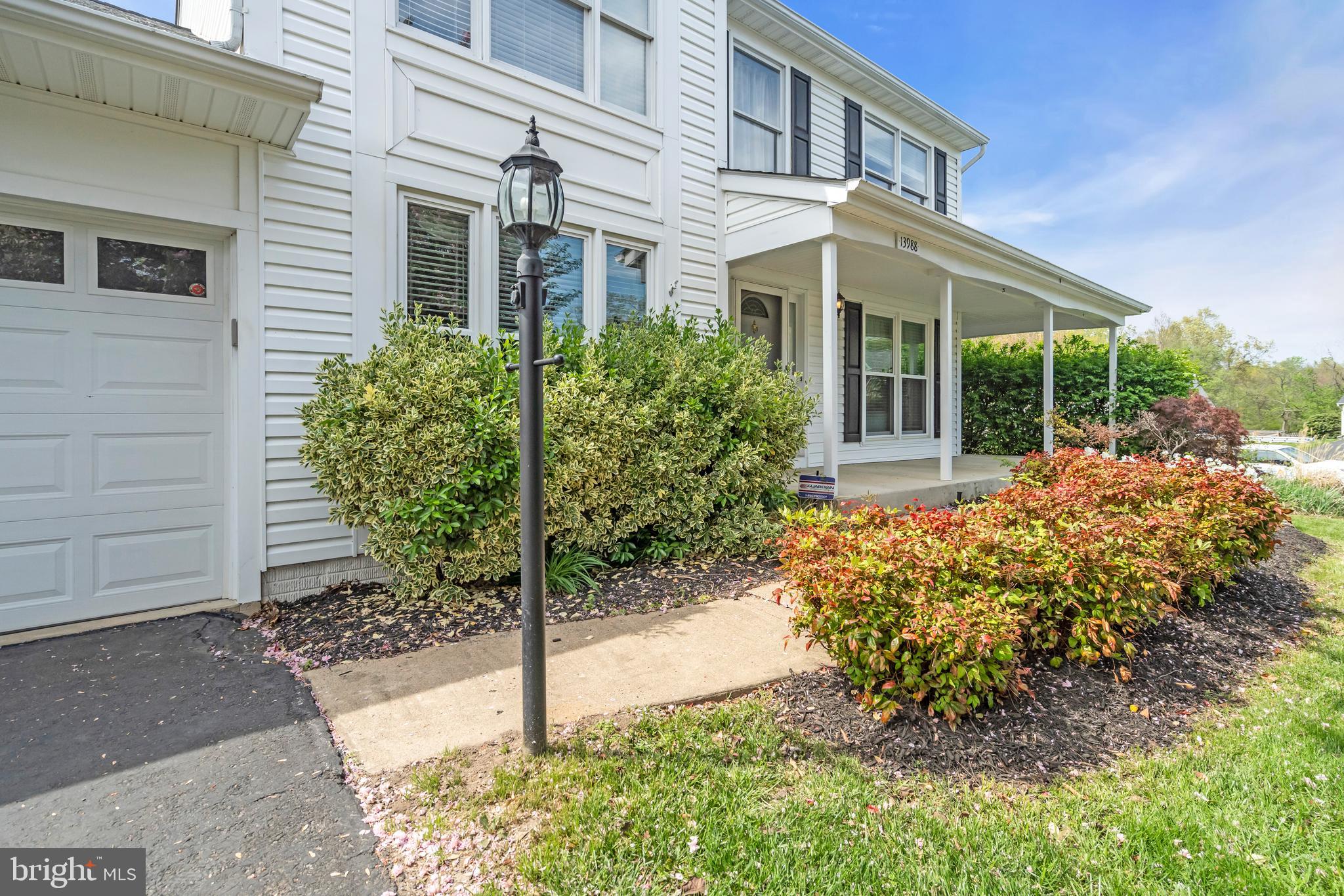 13988 Dancing Twig Drive Gainesville, VA 20155 - Photo 4 of 62 a front view of a house with garden