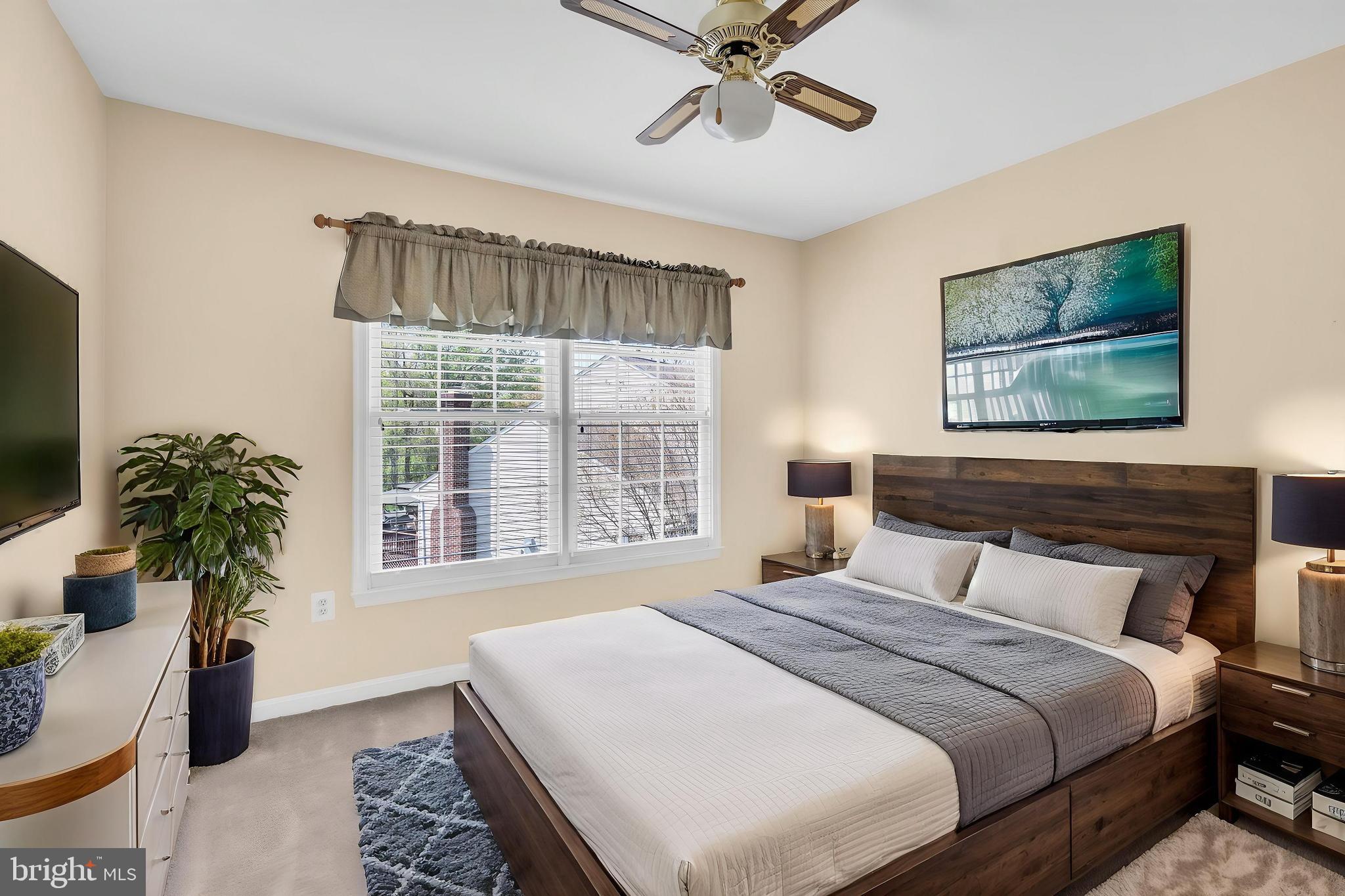 13988 Dancing Twig Drive Gainesville, VA 20155 - Photo 41 of 62 a bedroom with a large bed and a chandelier