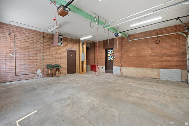 673 East 700 South Springville, UT 84663 - Photo 38 of 43 Spacious interior featuring exposed brick walls, concrete flooring, and a ceiling-mounted heater