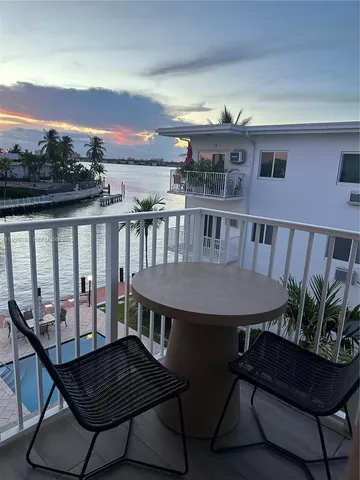 a view of a chairs and table on the roof deck