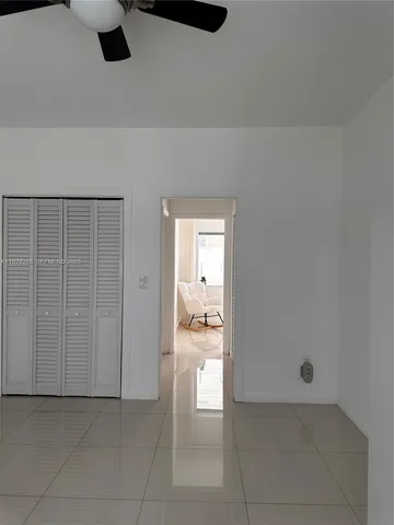 a kitchen with windows and refrigerator