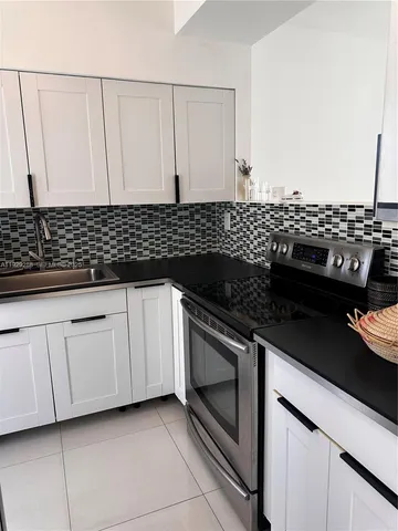 a close view of a stove a microwave and cabinets