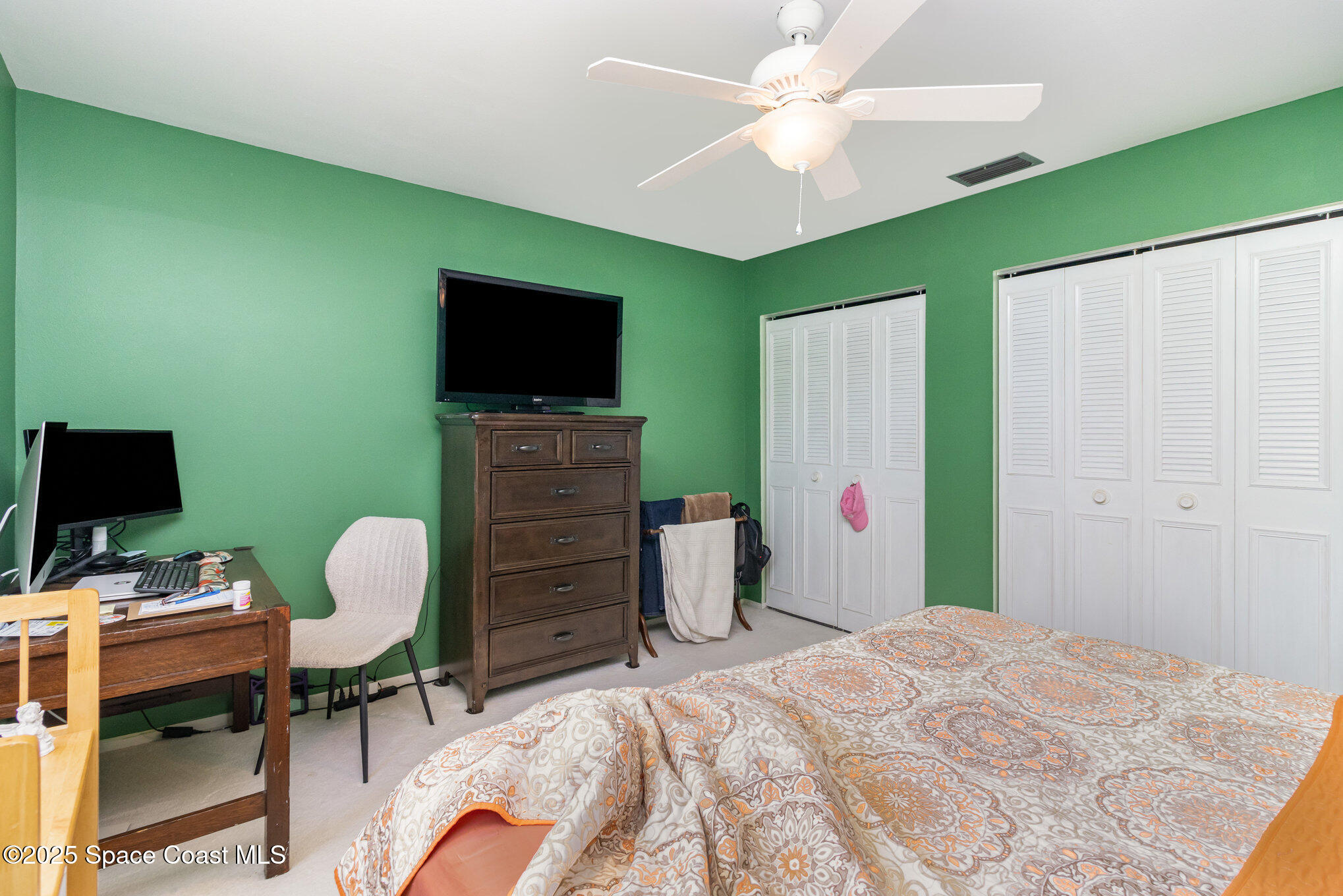415 School Road, Unit 70 Indian Harbour Beach, FL 32937 - Photo 11 of 16 a bedroom with a bed and a flat screen tv