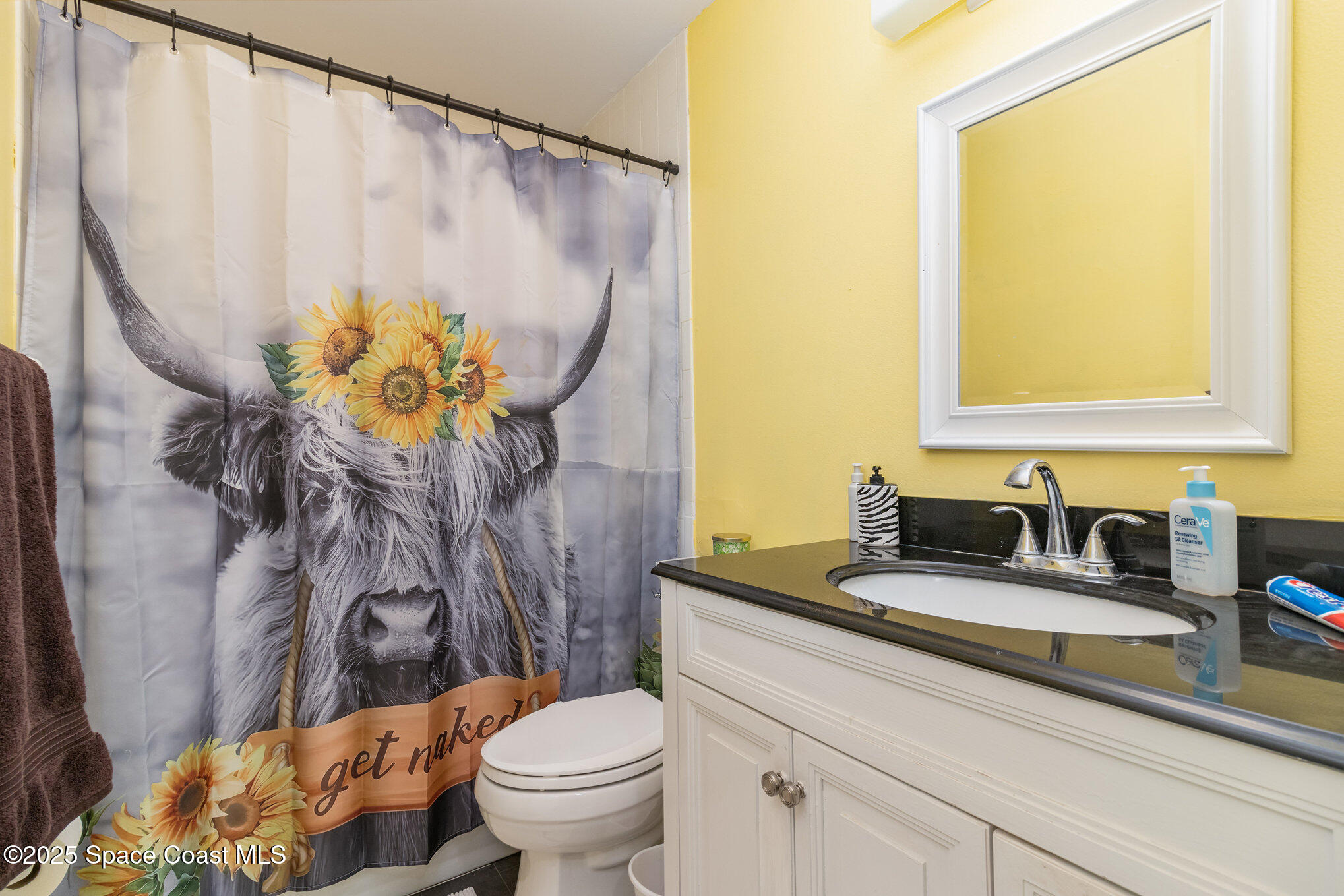415 School Road, Unit 70 Indian Harbour Beach, FL 32937 - Photo 13 of 16 a bathroom with a granite countertop sink a toilet and a mirror