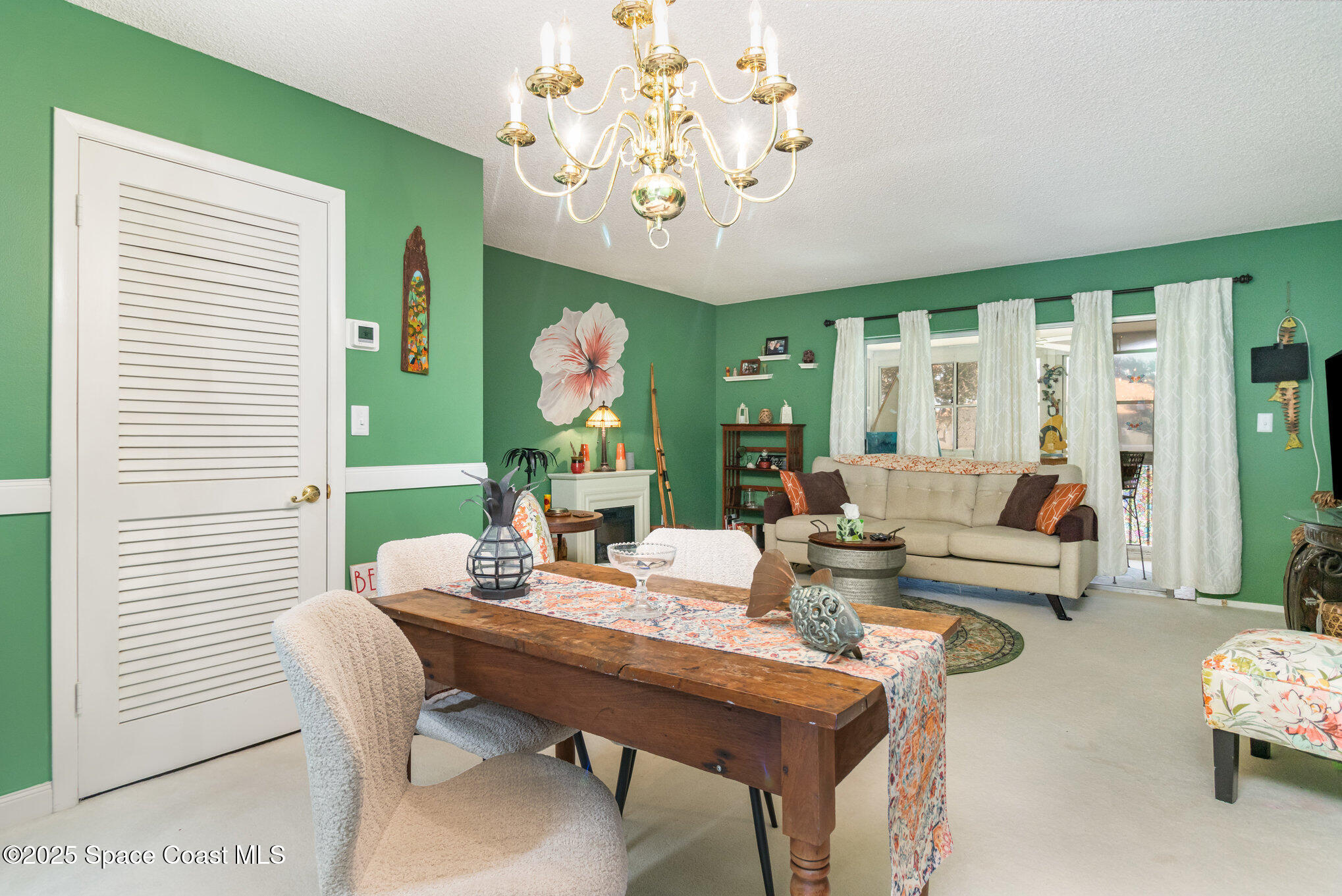 415 School Road, Unit 70 Indian Harbour Beach, FL 32937 - Photo 5 of 16 a living room with furniture and a large window