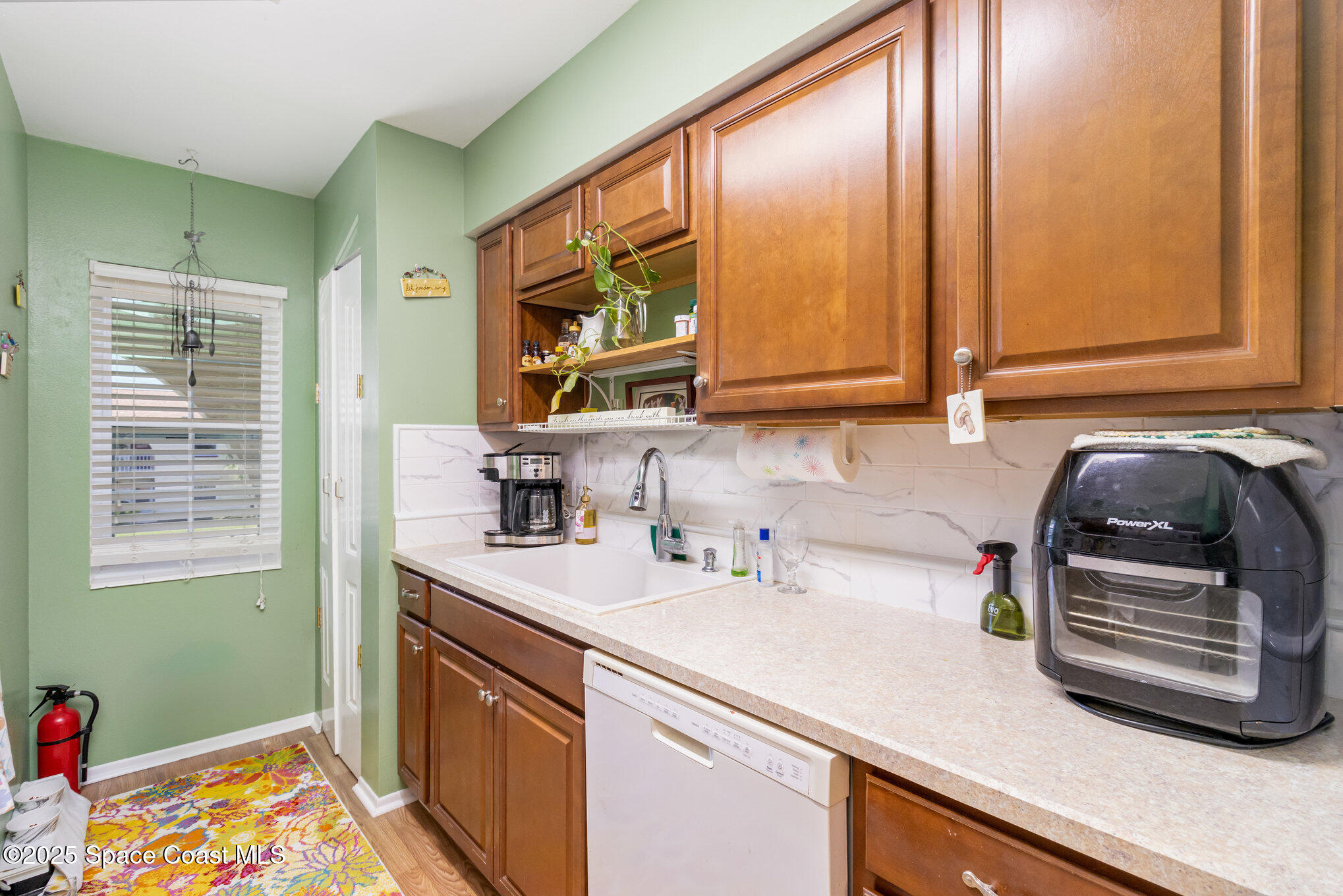415 School Road, Unit 70 Indian Harbour Beach, FL 32937 - Photo 6 of 16 a kitchen with a sink cabinets and window