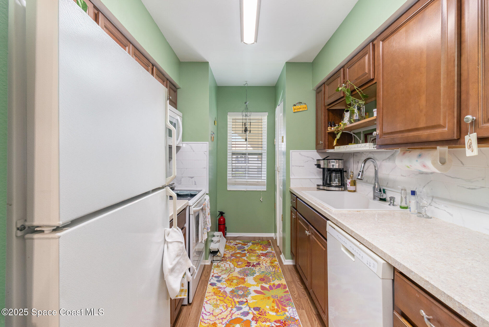 415 School Road, Unit 70 Indian Harbour Beach, FL 32937 - Photo 8 of 16 a kitchen with a sink appliances and cabinets