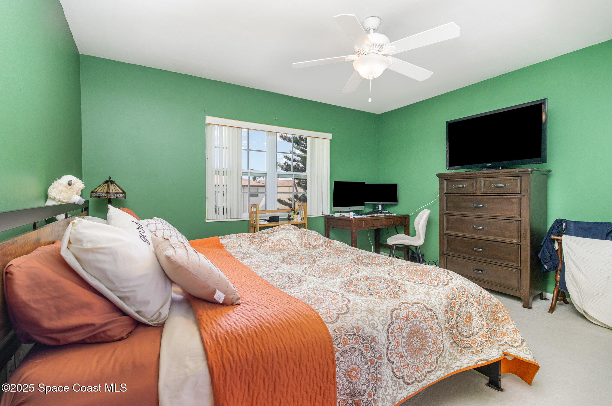 415 School Road, Unit 70 Indian Harbour Beach, FL 32937 - Photo 9 of 16 a bedroom with a bed and a flat screen tv