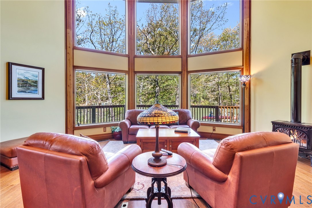 176 Baypointe Court Reedville, VA 22539 - Photo 21 of 59 a living room with furniture and a floor to ceiling window