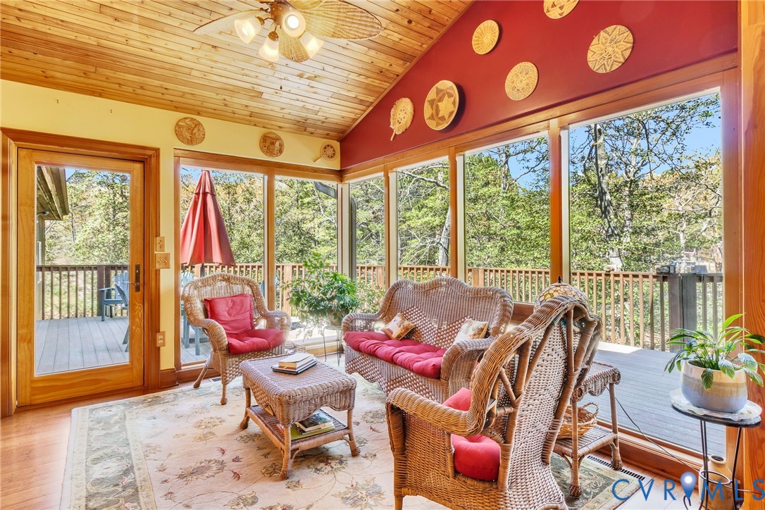 176 Baypointe Court Reedville, VA 22539 - Photo 23 of 59 a living room with furniture and floor to ceiling windows