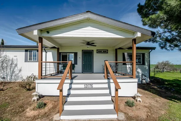 a front view of a house with a yard table and chairs