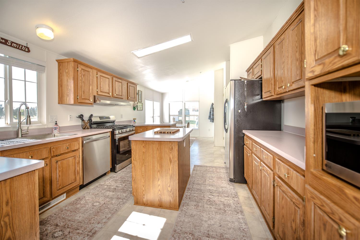 12076 County Road 84A Capay, CA 95607 - Photo 15 of 46 a kitchen with kitchen island granite countertop a stove a sink and a refrigerator
