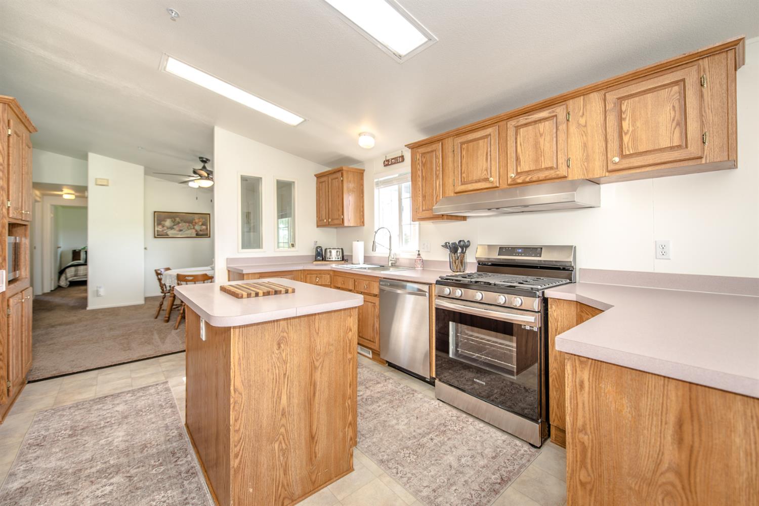 12076 County Road 84A Capay, CA 95607 - Photo 19 of 46 a kitchen with a stove sink and a refrigerator