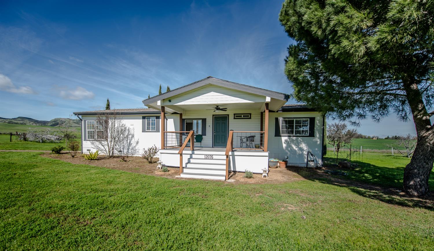 12076 County Road 84A Capay, CA 95607 - Photo 2 of 46 a front view of a house with a yard table and chairs