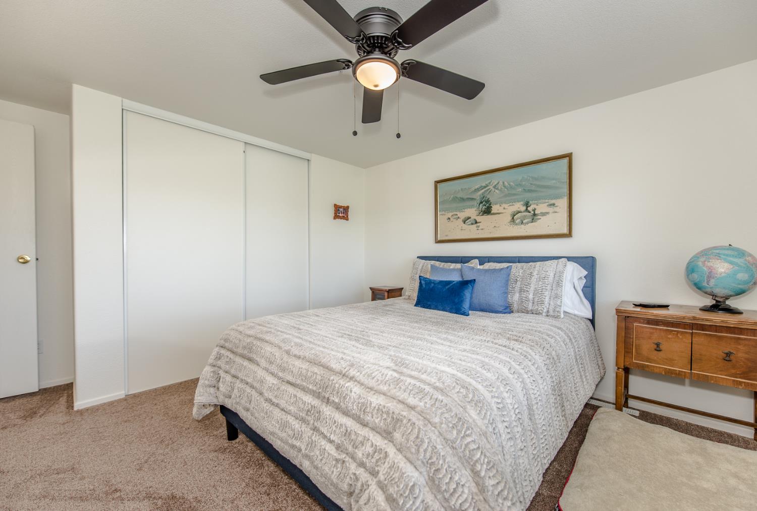 12076 County Road 84A Capay, CA 95607 - Photo 22 of 46 a bedroom with a bed and a chandelier